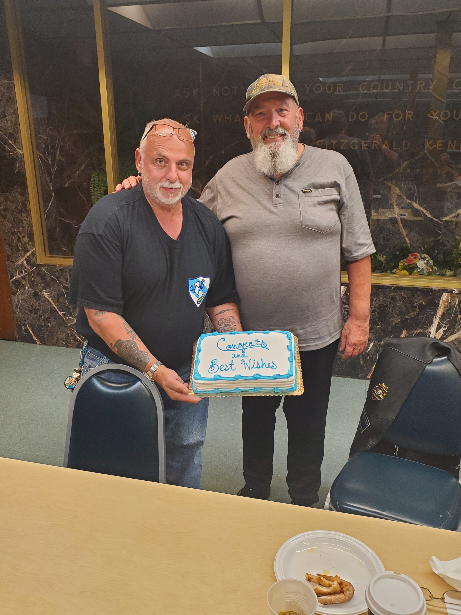 Gene Rosenfeld presents our VP Ed Defelice with a congratulatory cake for his recent marriage & upcoming move to Florida.